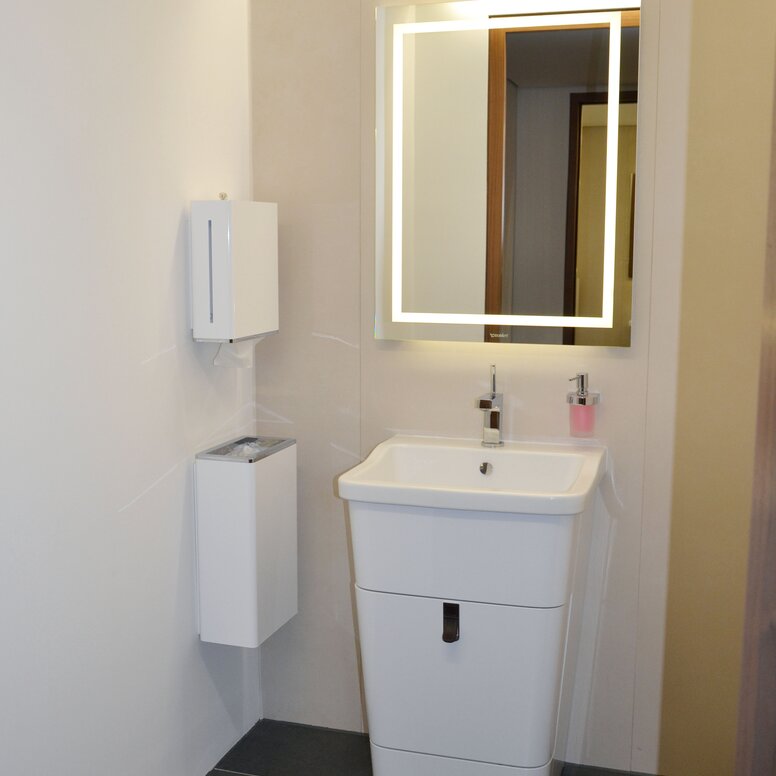 Museum for Architectural Drawings Bathroom equipped with soap dispenser, hygiene waste bin, mirror and paper towel dispenser